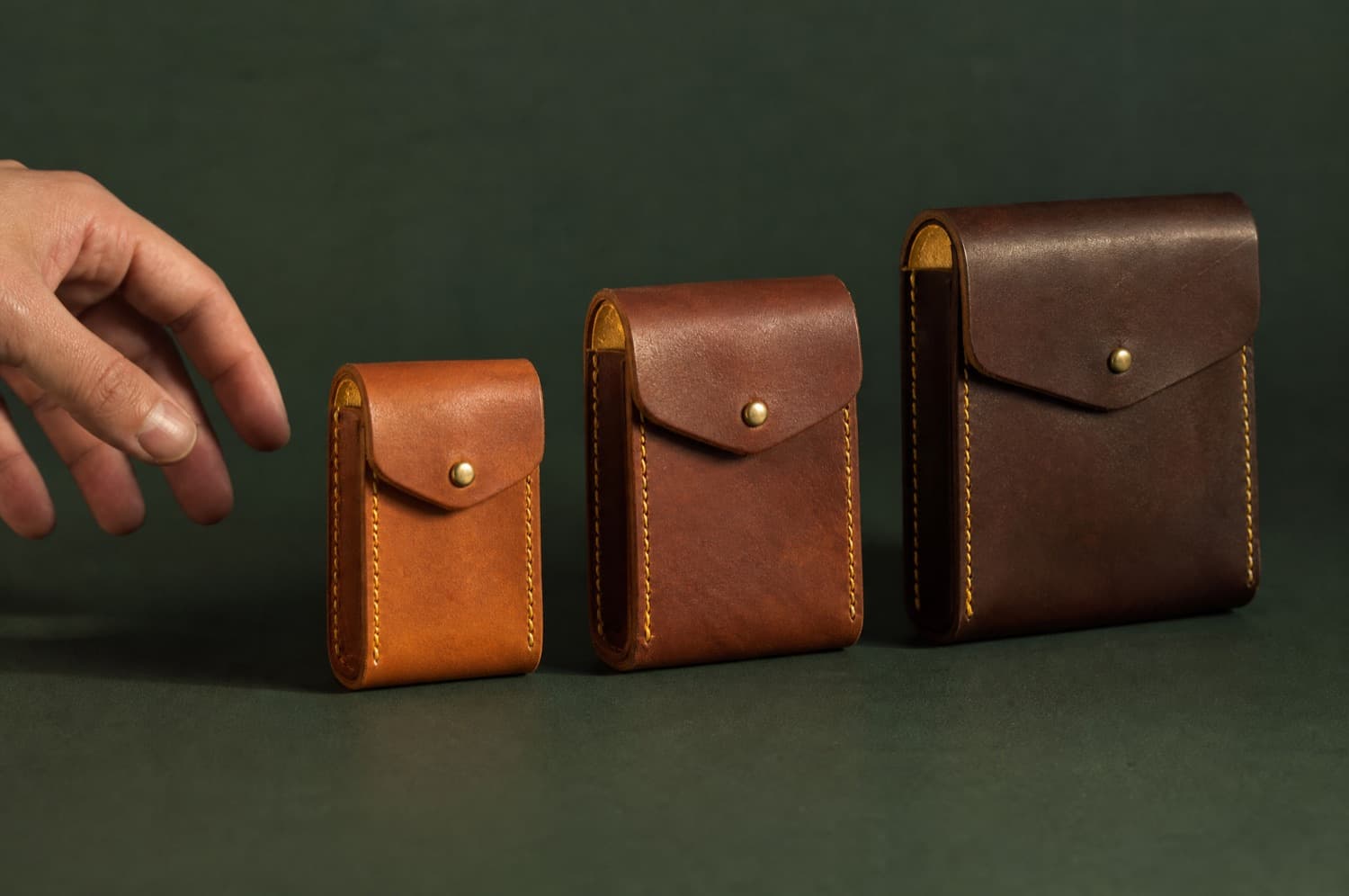 Coin Pouch photographed closed on a deep green ground